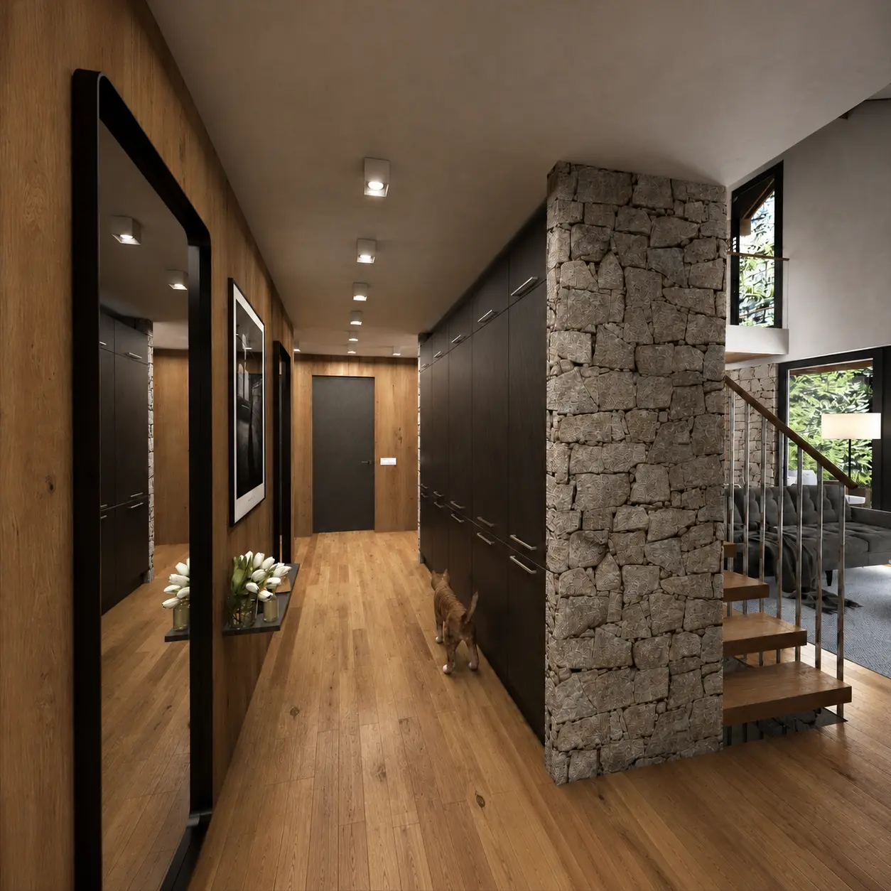 Eingangshalle mit Natursteinwand und offener Treppe